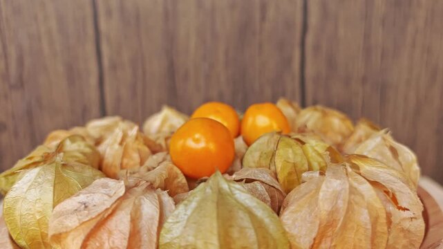 Cape gooseberry on wooden plate. 