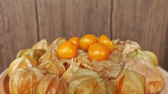 Cape gooseberry on wooden plate. 