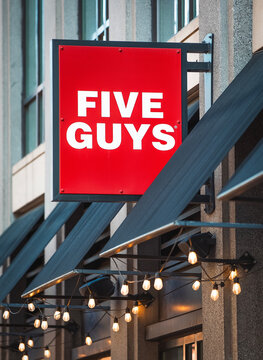 Five Guys burgers and fries restaurant red logo sign on a city building facade in Washington, D.C., USA, April 8, 2026.