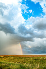 Obraz premium Rainbow After the Storm. Climate Change, Extreme Weather, Supercell Storms, Environmental Sustainability and Hope for a Changing Planet