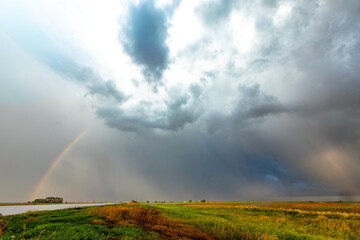 Obraz premium Rainbow After the Storm. Climate Change, Extreme Weather, Supercell Storms, Environmental Sustainability and Hope for a Changing Planet