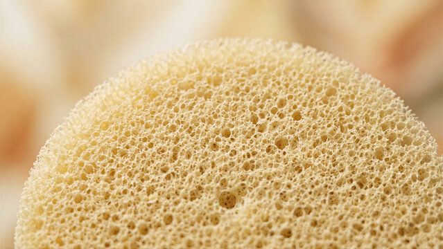 Abstract clean sensory background of a porous dense gray sponge material texture showing fine micro holes pattern