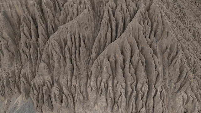 The spectacular multicolored badlands of Anjihai Grand Canyon in Xinjiang, China. Layers of sedimentary rock carved by water erosion and geological processes over millions of years create dramatic can