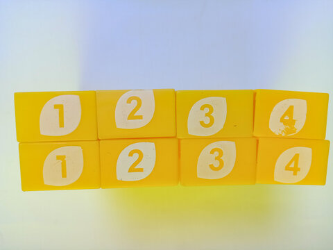 Bright yellow plastic numbered blocks on white background