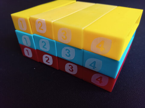 Colorful numbered plastic toy blocks stacked in order.