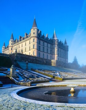 Majestic historic castle beside serene river at dusk.