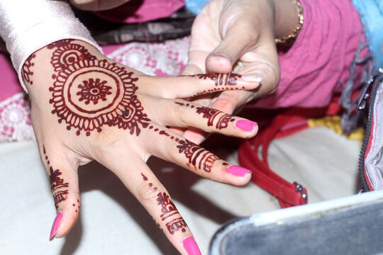 hands of the girl with a henna painting