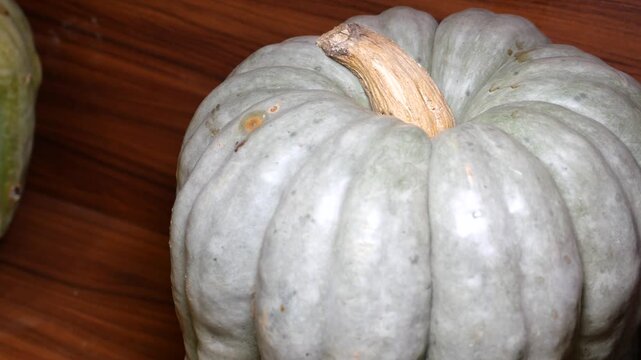 Pumpkin on wooden shelf in indoor space