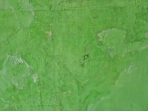 Close up of green concrete wall damaged by moisture and salt efflorescence