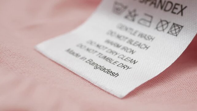 Clothing care label shows washing instructions and origin