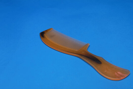 comb isolated on blue background