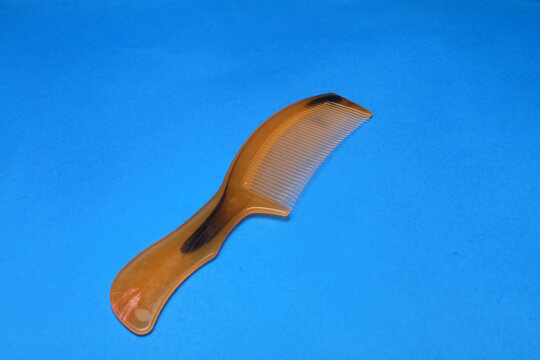 comb isolated on blue background