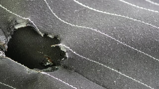 Fabric with holes shown in close up at a local shop