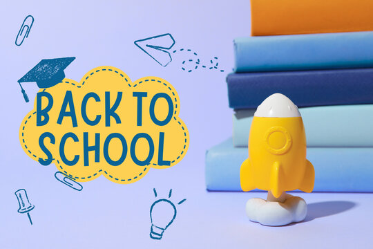 Back to school, Brightly colored rocket figurine stands near neatly stacked books