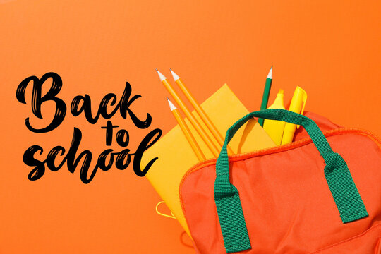 Back to school, Colorful school supplies arranged on vibrant orange background