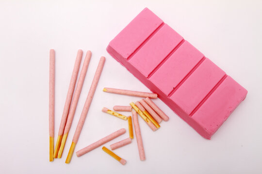 chocolate pink bar with pink stick on white table