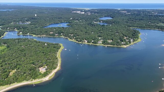 The shallow waters of Pleasant Bay are seen from a bird's eye view on a summer day. This beautiful body of water, fed by the Atlantic Ocean, is a part of Orleans and Chatham, Cape Cod, Massachusetts.