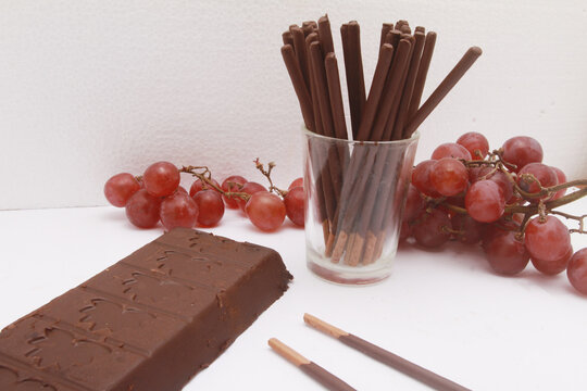 chocolate bar with chocolate stick on glass