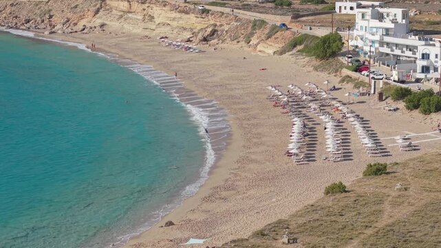 Static overhead drone view capturing the pristine golden sandy shoreline of Lefkos Beach and crystal-clear turquoise waters on Karpathos Island in Greece.
