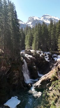 Simmen Falls waterfall in Lenk im Simmental, Switzerland Bernese Highlands vertical video