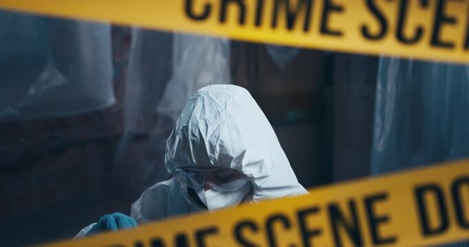 Forensic investigator seals a spent cartridge case inside an evidence bag for ballistic examination behind crime scene tape.