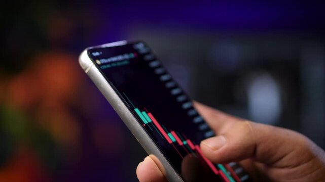 Trader Analyzing Market Chart on Smartphone