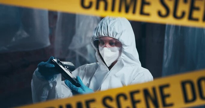 Crime scene forensic specialist examines a firearm as part of a professional evidence collection process