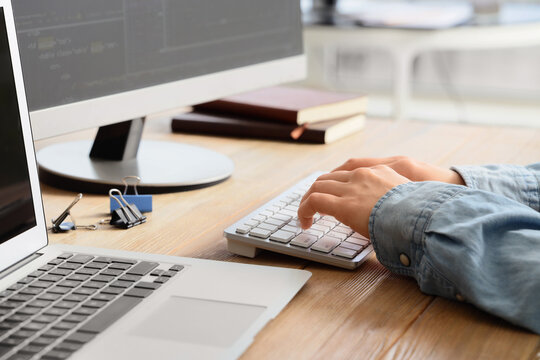 Female programmers hands testing code on computer in office, closeup
