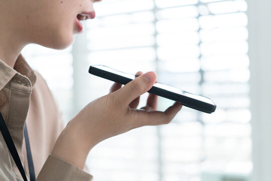 Young Businesswoman Working at Office Desk While Managing Documents and Mobile Communication.