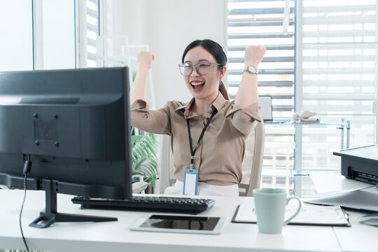 Young Businesswoman Working at Office Desk While Managing Documents and Mobile Communication.