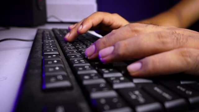 Person Typing on Computer Keyboard in Modern Workspace