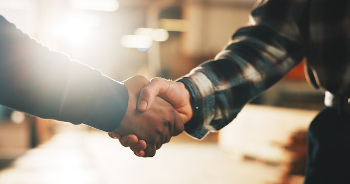 Carpenter, people and handshake in warehouse for wood production partnership, b2b or deal together. Employees, colleagues or shaking hands with lens flare in carpentry workshop for business agreement