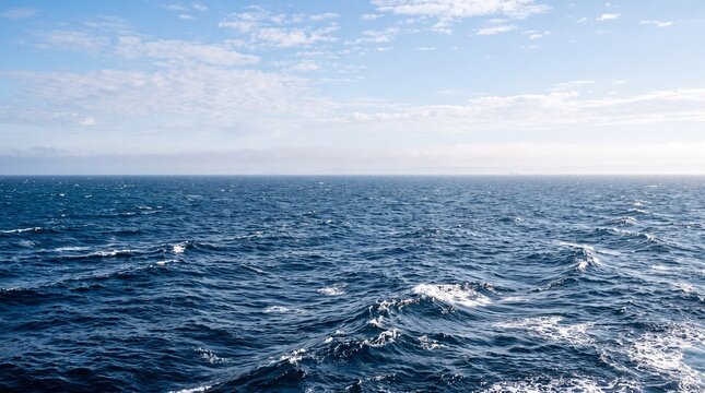 Endless open sea with gentle deep blue waves and white crests stretching toward a clean atmospheric horizon line, detailed st, representing geographic grandeur, planetary beauty, and marine travel.