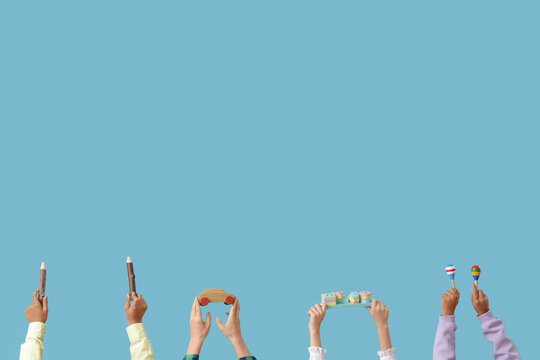 Children with different toys on blue background