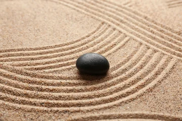 Fotobehang Rustgevend Black spa stone on light sand with pattern  © Pixel-Shot