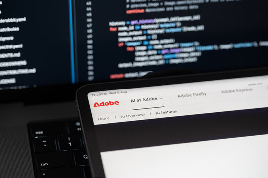 Adobe Ai company web page on program code background