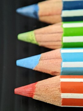 close up of colored pencils. Selective focus of colour pencils on black background 