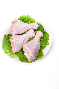 Raw Chicken Thighs on Plate with Fresh Lettuce - Quality Poultry Meat for Retail Display