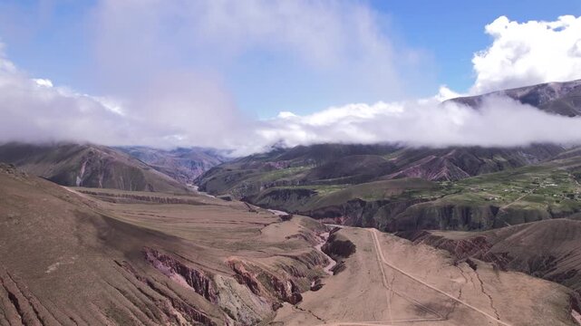 4K drone aerial view of the winding mountain road to Iruya, Jujuy, Argentina. Scenic zigzag route crossing the Andes with dramatic landscapes and remote valleys.
