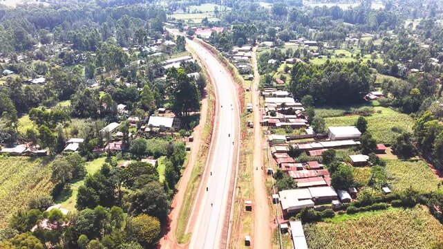 Aerial wide shot of showing modern skyline of Rural kenya settlement with old architectures in background and poor ghetto suburb district of Kibera in foreground.