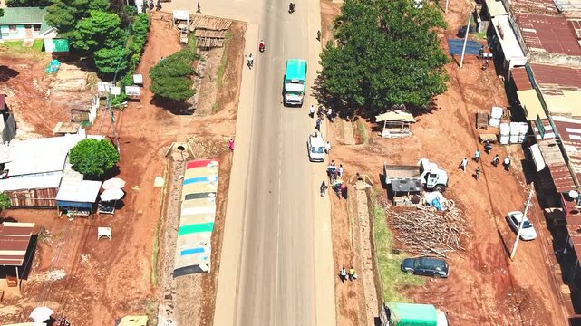 Aerial wide shot of showing modern skyline of Rural kenya settlement with old architectures in background and poor ghetto suburb district of Kibera in foreground.