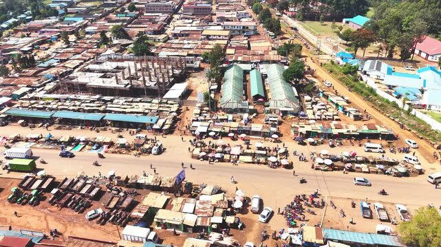 Aerial wide shot of showing modern skyline of Rural kenya settlement with old architectures in background and poor ghetto suburb district of Kibera in foreground.