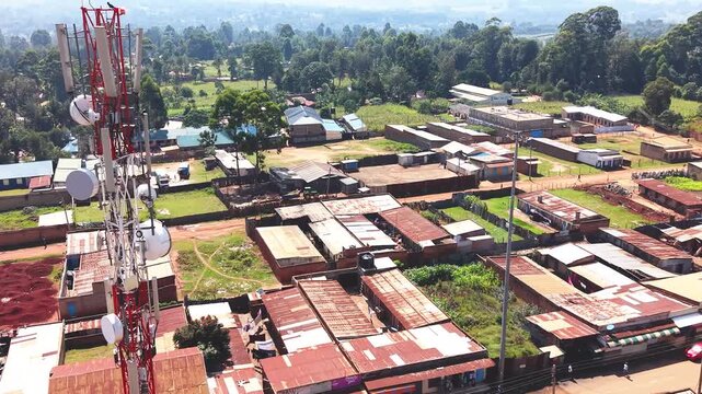 Communication mask, telecommunication Aerial wide shot of showing modern skyline of Rural kenya settlement with old architectures in background and poor ghetto suburb district of Kibera.