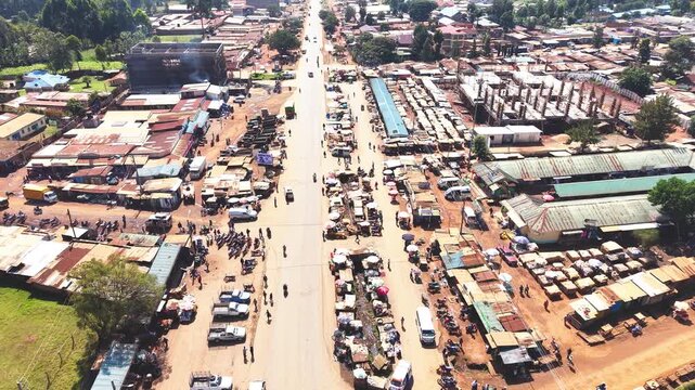 Aerial wide shot of showing modern skyline of Rural kenya settlement with old architectures in background and poor ghetto suburb district of Kibera in foreground.