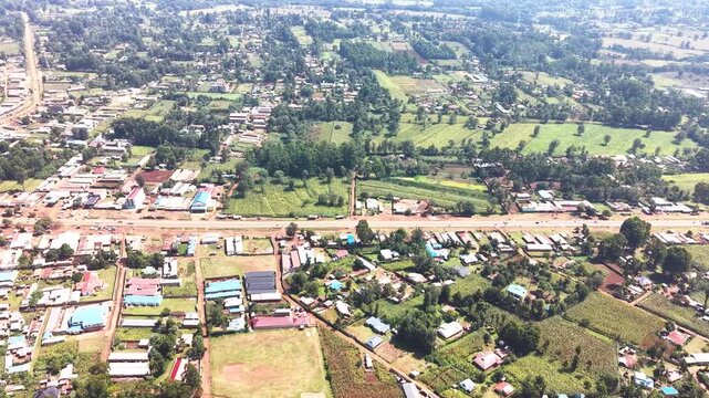Aerial wide shot of showing modern skyline of Rural kenya settlement with old architectures in background and poor ghetto suburb district of Kibera in foreground.