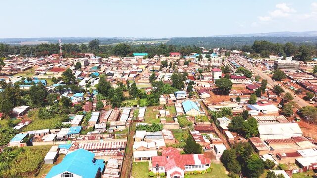 Aerial wide shot of showing modern skyline of Rural kenya settlement with old architectures in background and poor ghetto suburb district of Kibera in foreground.