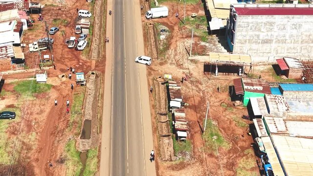 Aerial wide shot of showing modern skyline of Rural kenya settlement with old architectures in background and poor ghetto suburb district of Kibera in foreground.