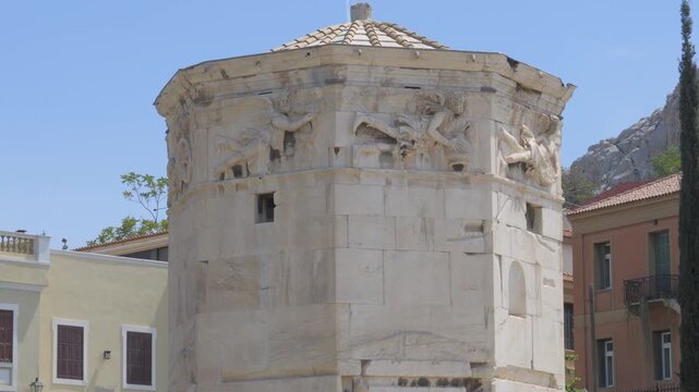 Ancient marble Tower of the Winds with carved wind gods frieze in Athens Greece