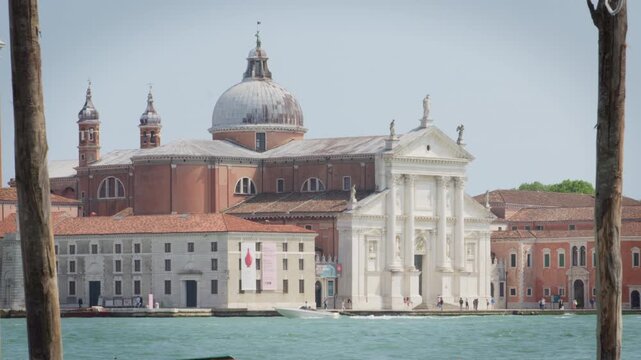 Waterfront view of San Giorgio Maggiore Basilica, its dome and classical facade rising above the lagoon in Venice, Italy.