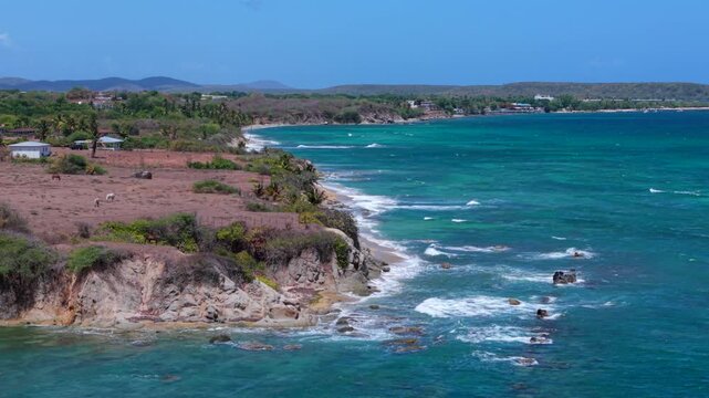 Panoramic drone fly at scenic tropical Vieques coastline with rocky cliffs overlooking vibrant turquoise Caribbean Sea, Puerto Rico